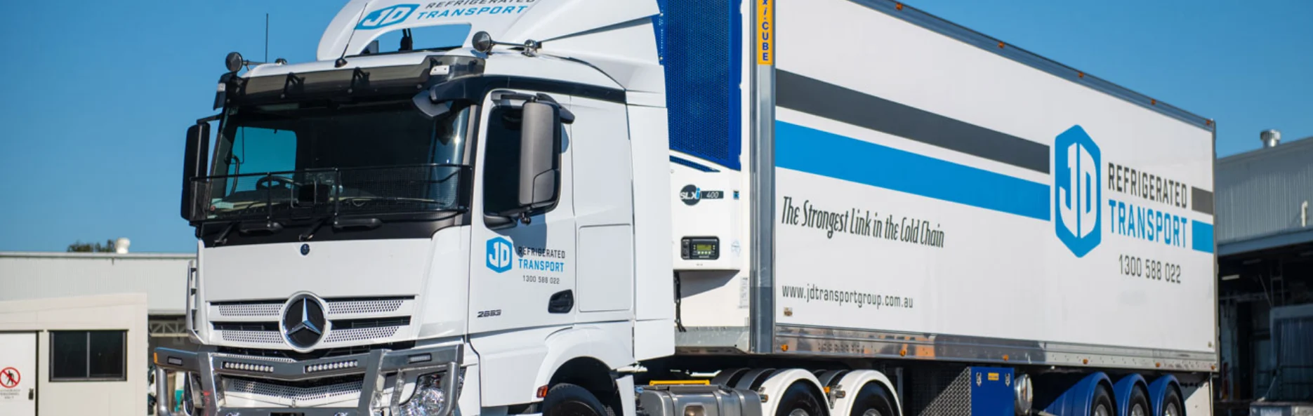 A JD Refrigerated Transport Mercedes-Benz prime mover and refrigerated trailer at the depot